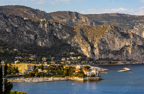 Panoramic view of Saint-Jean-Cap-Ferrat resort town on Cap Ferrat cape with exclusive estates and Alpes at French Riviera of Mediterranean Sea in France