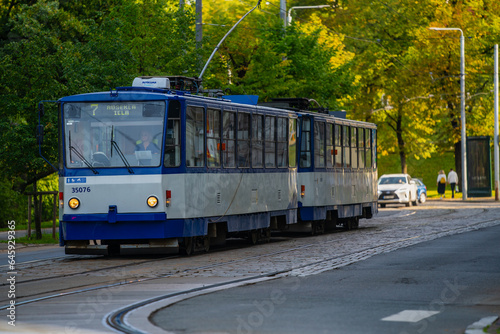 Old tram on cobble stone track road in European city - Riga, Latvia