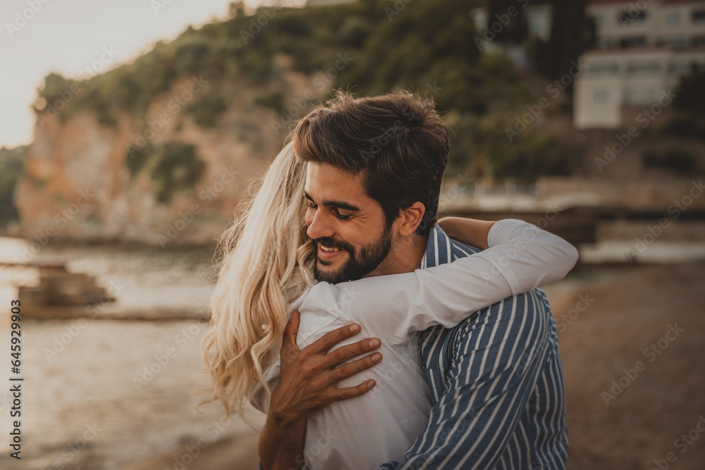 Romantic man in love hugging his girlfriend at the beach, enjoying their vacation. Romantic man in love hugging his girlfriend at the beach, enjoying their vacation.