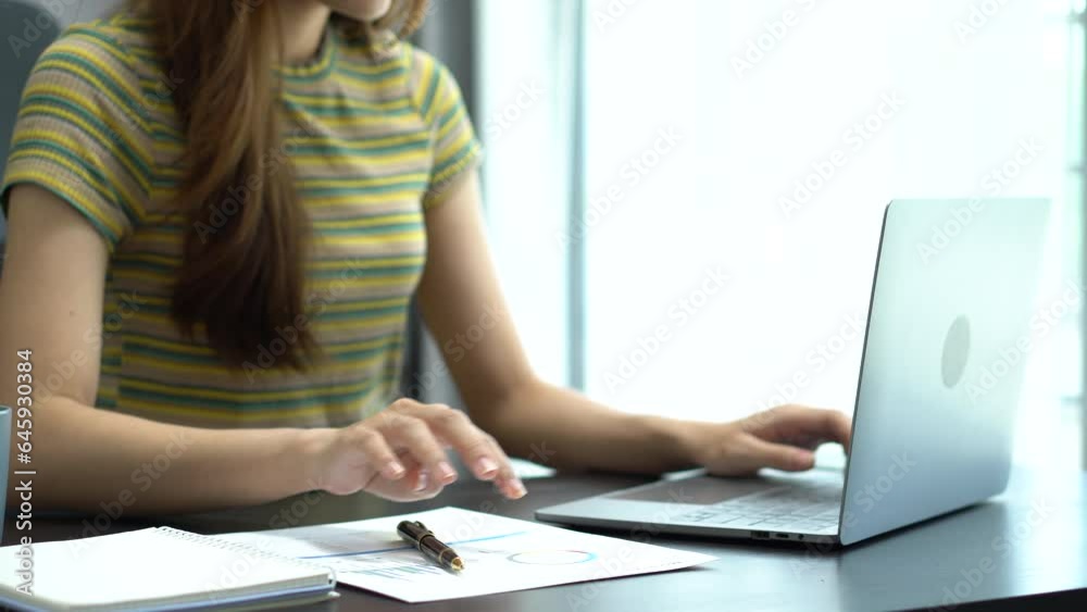 Women work on laptop on the table at the office with information documents. Women work on laptop on the table at the office with information documents.