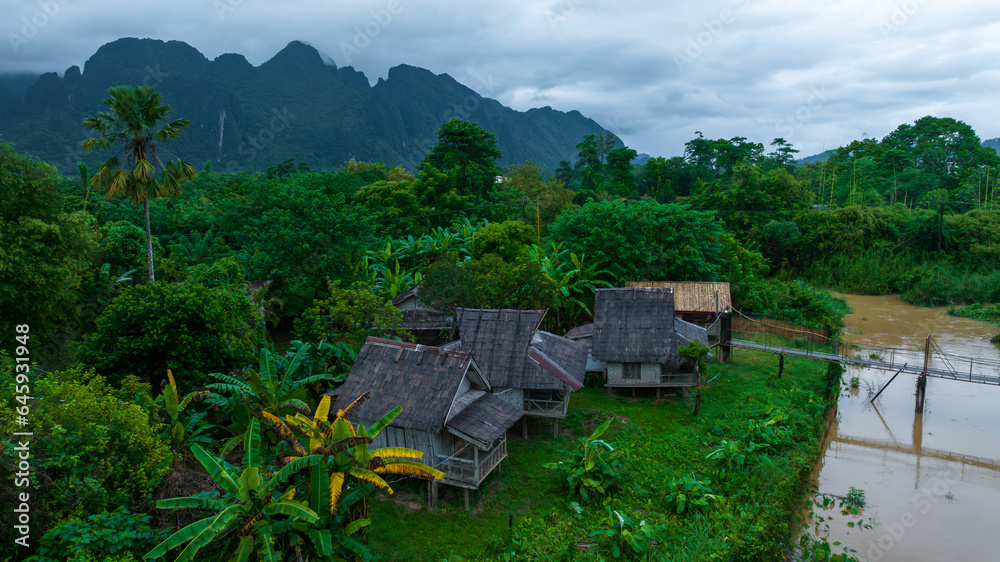 Village and mountain in Vang Vieng, Laos, Nam Song River in Vang Vieng, Laos. Village and mountain in Vang Vieng, Laos, Nam Song River in Vang Vieng, Laos.