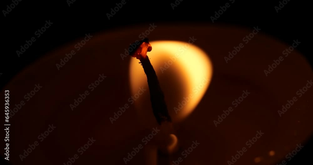 a candle goes out. macro shot of a flame from a candle going out. wind blowing out a flame. burning candle wick in macro view. blow out a candle
