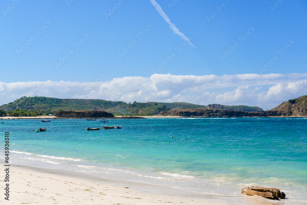 The most beautiful beach in Lombok and the closest to Kuta is Tanjung Aan Beach, A Hidden Gem Waiting for You to Explore on Lombok. beautiful beach surrounded by hills and blue sea