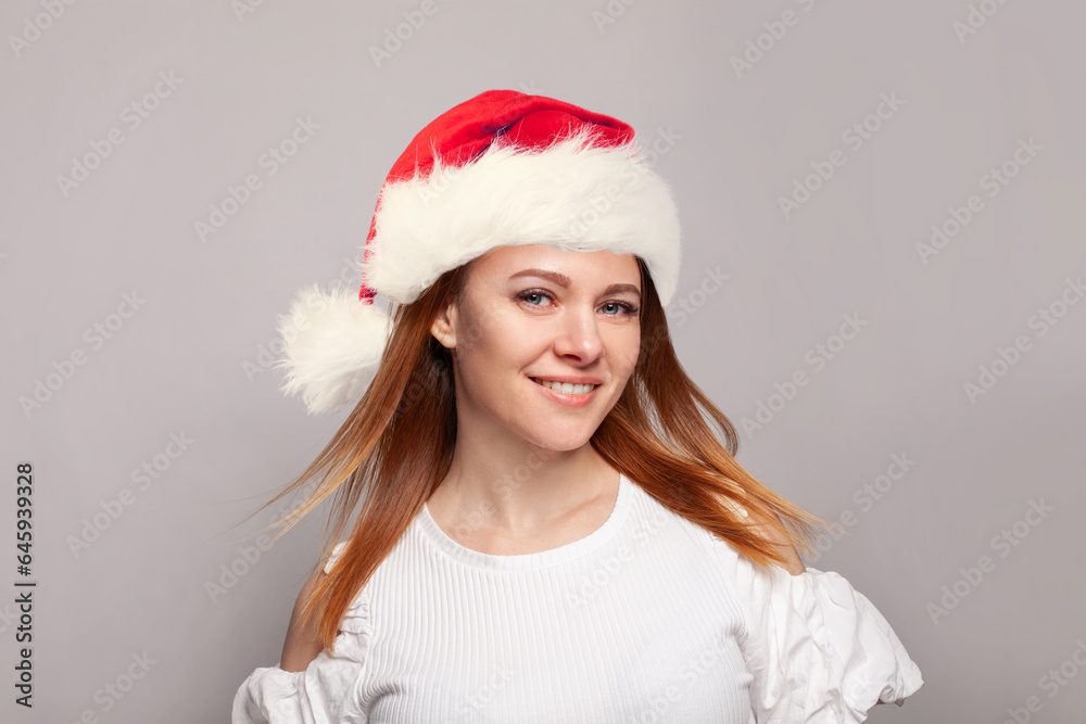 Beautiful Christmas woman wearing red Santa hat smiling, Xmas portrait Beautiful Christmas woman wearing red Santa hat smiling, Xmas portrait