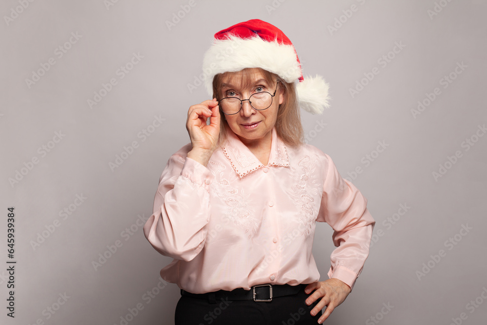 Xmas woman granny in red Santa hat, Christmas portrait Xmas woman granny in red Santa hat, Christmas portrait