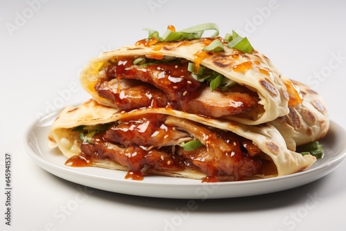 A white plate topped with a chicken quesadilla. Fictional image. Peking duck, chinese dish.