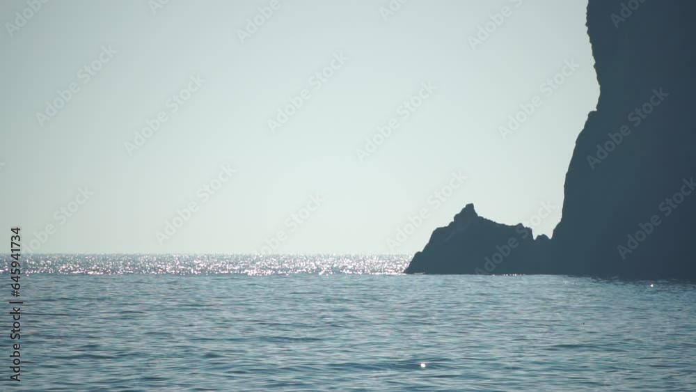 Aerial view on calm azure sea and volcanic rocky shores. Small waves on water surface. Nature summer ocean sea beach view. Nobody. Holiday, vacation and travel concept. Weather and climate change Aerial view on calm azure sea and volcanic rocky shores. Small waves on water surface. Nature summer ocean sea beach view. Nobody. Holiday, vacation and travel concept. Weather and climate change