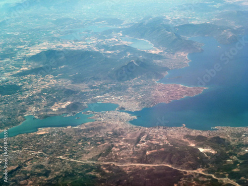 Top view of distant sea bay and mountains. View from the plane