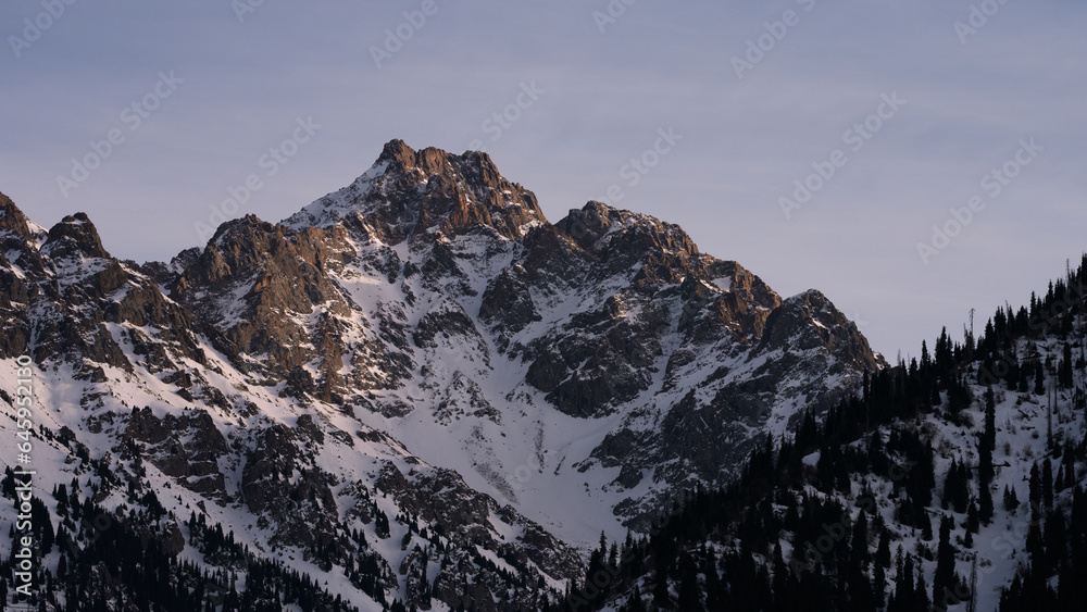 Alatau mountains with warm sunset light in early spring