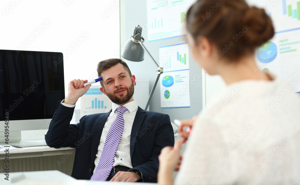 Portrait of handsome smiling man. Board member speaking and ask questions to manager about financial statements. Company and business meeting concept. Blurred background Portrait of handsome smiling man. Board member speaking and ask questions to manager about financial statements. Company and business meeting concept. Blurred background