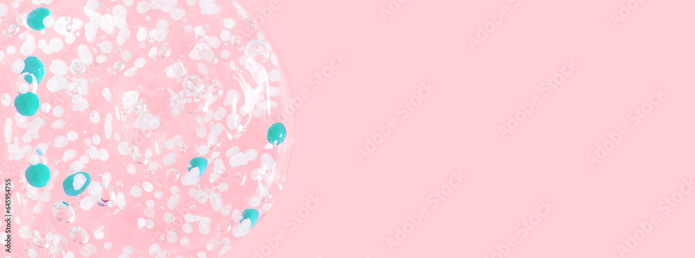 smears and drops of transparent gel with blue granules. On a pink background. - obrazy, fototapety, plakaty 