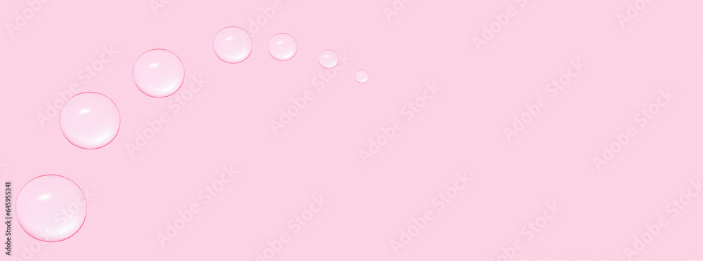 Drops of transparent gel or water in the shape of a semi-circle, with decreasing size. On a pink background.
