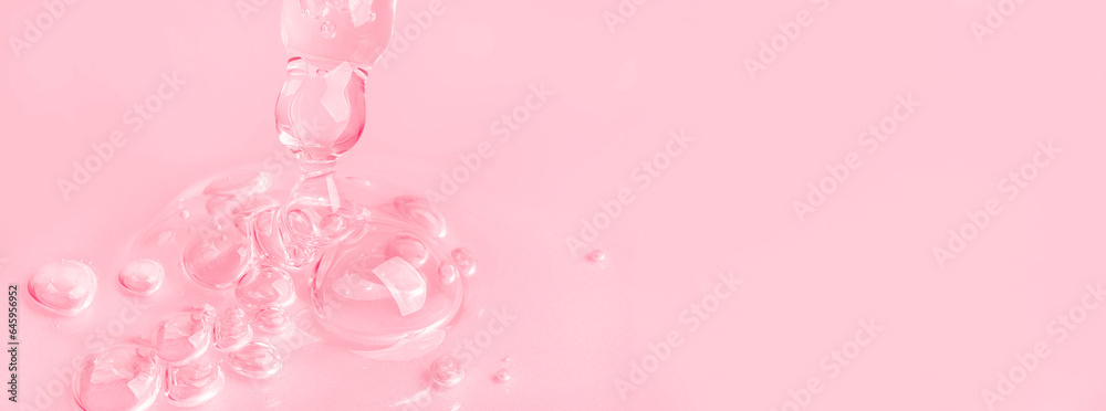 Dropping gel from an eyedropper on a pink background. Cosmetics Lab. Serum, gel, retinol, oil.