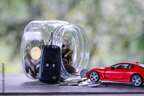 Car model on money coins pile. Finance and car loan, saving money for a car, coins insurance, loan and buying car finance concept. buy and installments down payment a car.