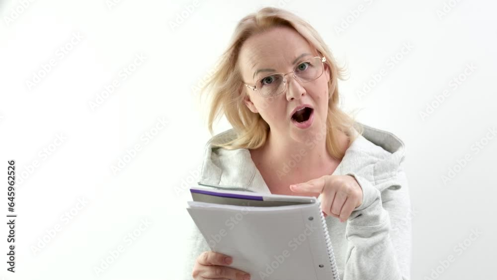 the teacher points with her finger at a notepad with her mouth open glasses on a blonde beautiful people to attract attention instructions look here Pay attention to this item. manager the teacher points with her finger at a notepad with her mouth open glasses on a blonde beautiful people to attract attention instructions look here Pay attention to this item. manager