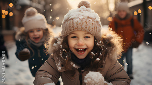 Cute little girls having fun on a snowy winter day outdoors.