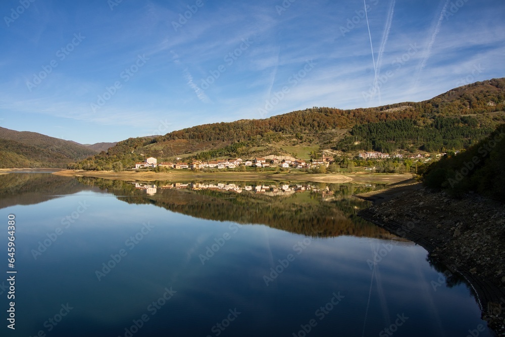Village surrounded by a natural Landscape overlooking a Mountain Lake
