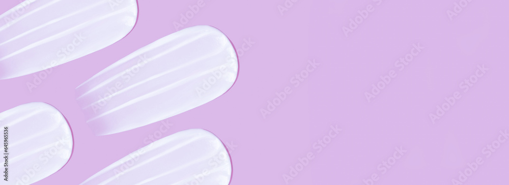 The background is cosmetic. Many smears of cream on a pink pink background The background is cosmetic. Many smears of cream on a pink pink background