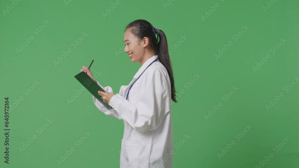 Side View Of Asian Female Doctor With Stethoscope Taking Note On A Tablet While Walking On Green Screen Background In The Hospital
Side View Of Asian Female Doctor With Stethoscope Taking Note On A Tablet While Walking On Green Screen Background In The Hospital