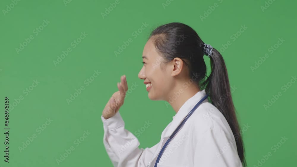 Close Up Of Side View Asian Female Doctor With Stethoscope Waving Hand And Smiling While Walking On Green Screen Background In The Hospital
Close Up Of Side View Asian Female Doctor With Stethoscope Waving Hand And Smiling While Walking On Green Screen Background In The Hospital