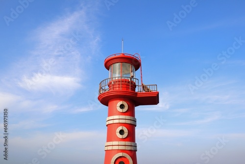 a red lighthouse in the sky