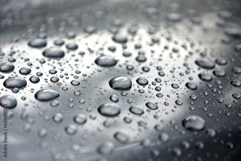 Water drops collect on top of metallic car surface, Rain droplets, circular liquid Water drops collect on top of metallic car surface, Rain droplets, circular liquid