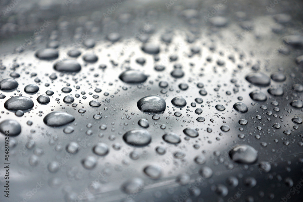 Water drops collect on top of metallic car surface, Rain droplets, circular liquid