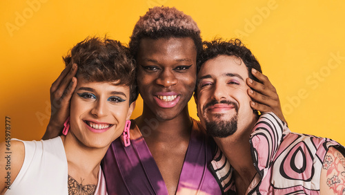 Multiracial transgender men smiling at the camera together