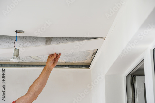 Worker assemble a suspended ceiling. photo
