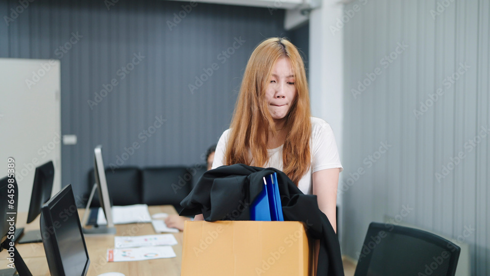 Asian woman employee stressed and fed up after quitting her job. A women holding a box of things and very upset with fired. Woman was fired from the corporation. Unemployment, Dismissal Asian woman employee stressed and fed up after quitting her job. A women holding a box of things and very upset with fired. Woman was fired from the corporation. Unemployment, Dismissal