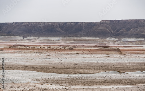 Hills of chalk and limestone and slopes of multi-colored mountains with weathering and washouts from water  colored relief in the steppe