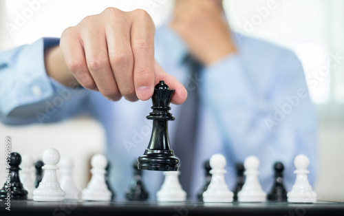 hand of businessmen moving chess in competition shows leadership, followers and business success strategies