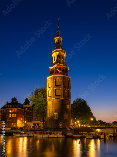Montelbaan tower, Amsterdam, Netherlands. Evening cityscape. Dark sky and cit...