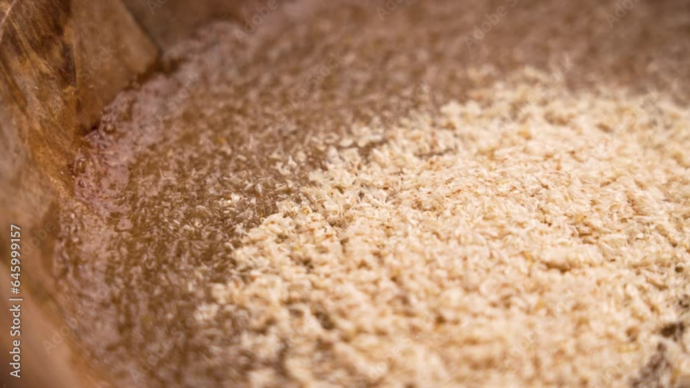 Ayurvedic psyllium husks in a water to prepare a healthy supplement close up. Rotation