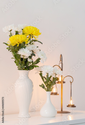 Wallpaper Mural chrysanthemums flowers in vases and burning candles on white interior Torontodigital.ca