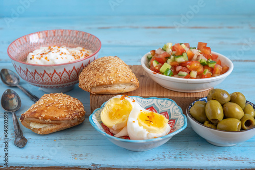 Food background with Israeli salad, pita bread stuffed with eggs and baked vegetables for tasty snack. 
