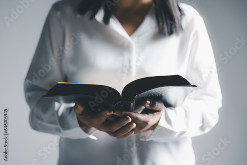 Worship christian with bible concept. Young woman person hand holding holy bible with study at home. Adult female christian reading book in church. Girl learning religion spirituality and pray to god.