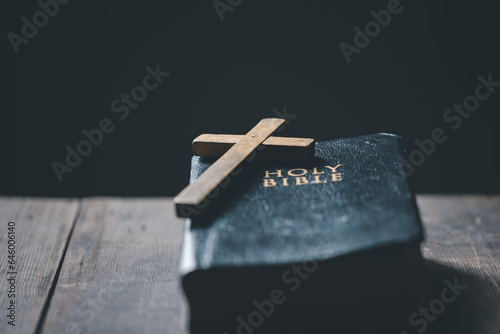 Spirituality, Religion and Hope Concept. Holy bible and cross on desk. Symbol of Humility, Supplication, Believe and Faith for Christian People.