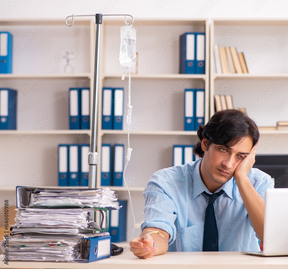 Young male employee in blood transfusion concept Young male employee in blood transfusion concept