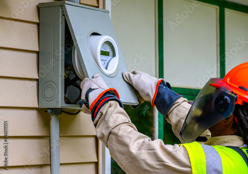An electrical technician removes the old Power Meter and replaces it with a new Smart Meter at our home in Windsor in Upstate NY.  PPE worn at all times by Worker.