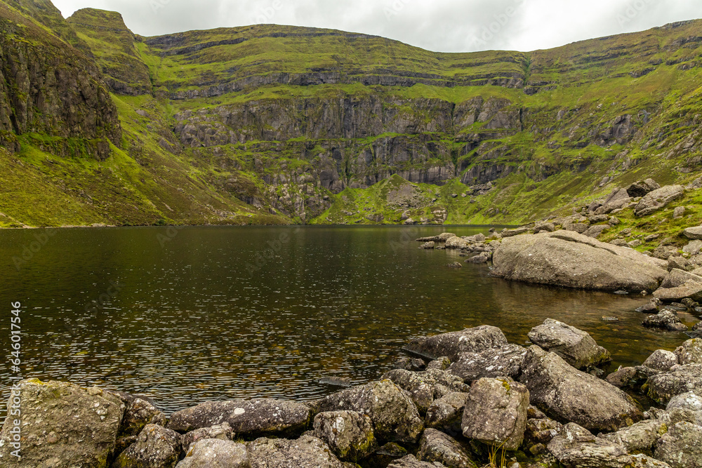 Coumshingaun Lough with rocks and vegetation