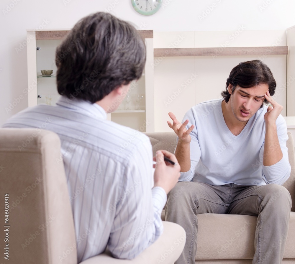 Young male patient discussing with psychologist personal problem Young male patient discussing with psychologist personal problem