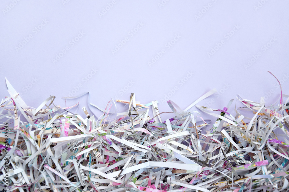 The shredded paper on light pink background. The shredded paper on light pink background.