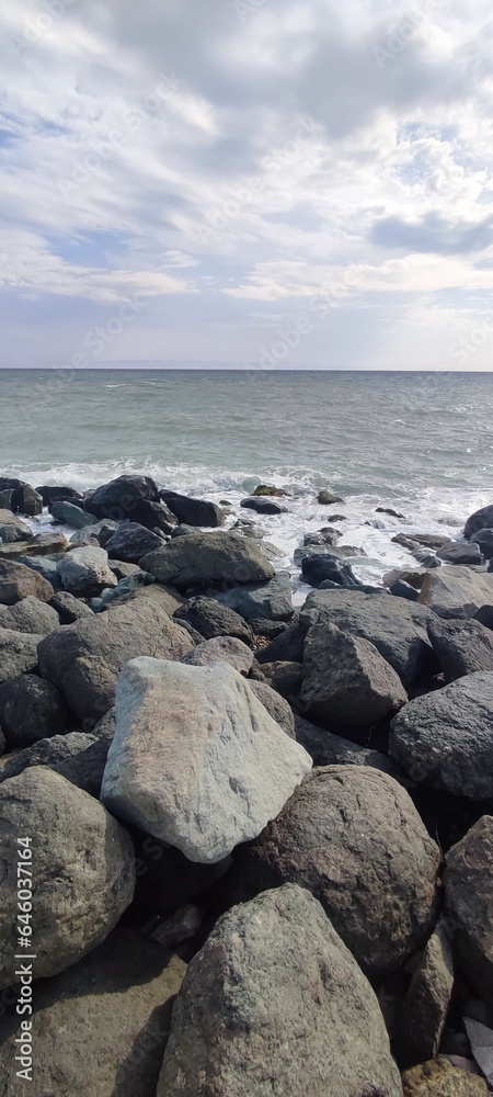 large mountain stones on the seashore large mountain stones on the seashore