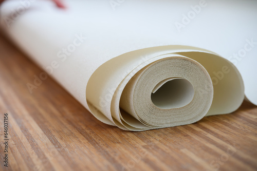 Close-up of a white roll of wallpaper.