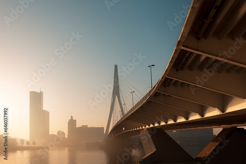 The Erasmusbrug in Rotterdam on a warm early morning in a misty sunrise