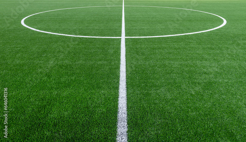 Fototapeta Naklejka Na Ścianę i Meble -  Green synthetic grass sports field with white line shot from above. Soccer, hurling, lacrosse, rugby, football, baseball sport concept