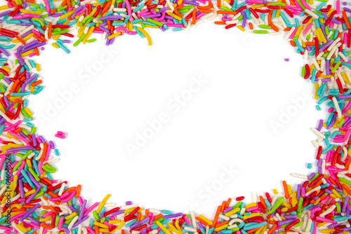 Frame made of colorful sprinkles on white background, top view. Confectionery decoration
