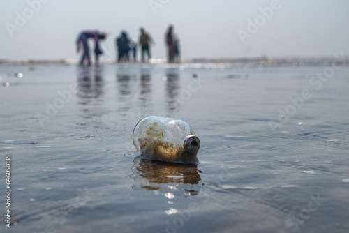 empty bottle on the beach sand 