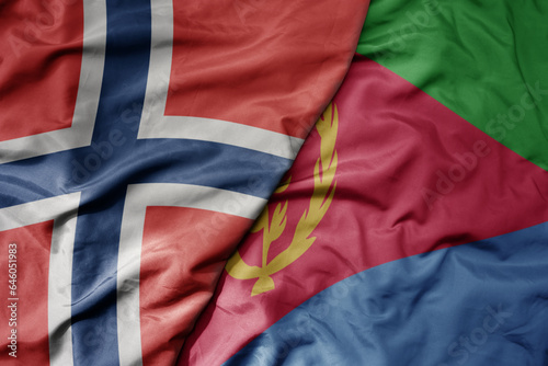 big waving national colorful flag of norway and national flag of eritrea .